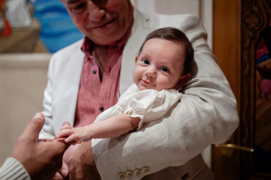 Baptism ceremony at a Sydney church, family gathered around the font